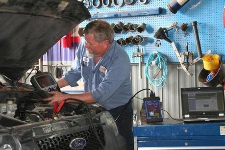 Technician fixing vehicle